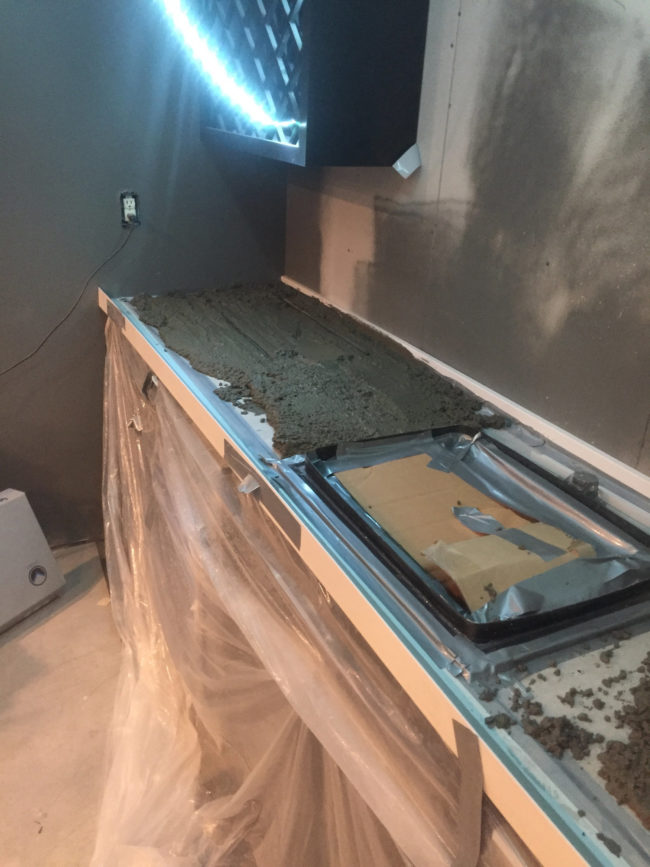 For the back bar, he attached the sink to one of the cabinets and filled the top around it with concrete.