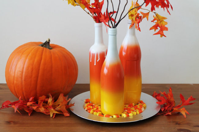 Reuse those empty wine bottles by making this awesome <a href="http://www.brit.co/ombre-bottles/" target="_blank">candy corn centerpiece</a>. 