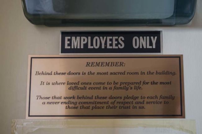 This is a sign for employees outside the embalming room on the second floor.