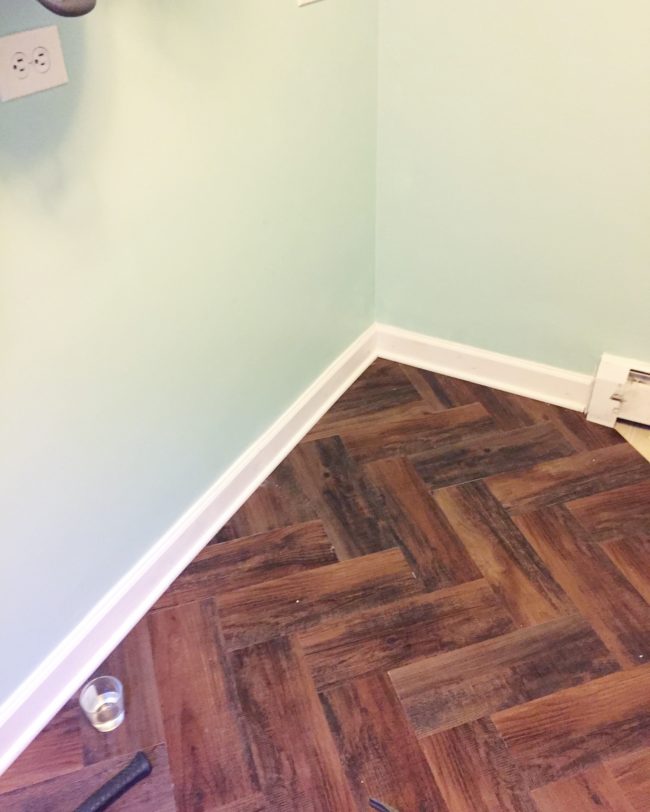 After she glued some new baseboards to the walls, the floor looked amazing.