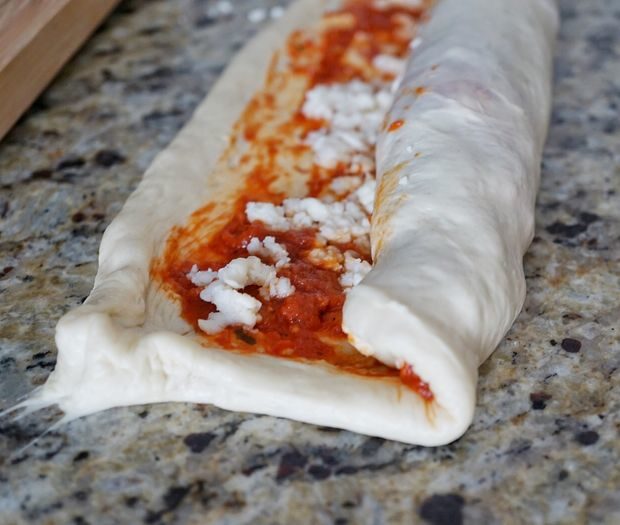 Here's where you get to mix it up -- roll your dough lengthwise. This creates layers upon layers of cheesy goodness.