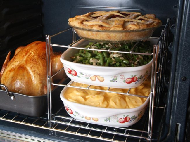 Don't waste hours cooking dinner one step at a time. This <a href="https://www.amazon.com/gp/product/B0018DYWFM/?_encoding=UTF8&tag=vira0d-20" target="_blank">three-tiered oven rack</a> can cook everything at once.
