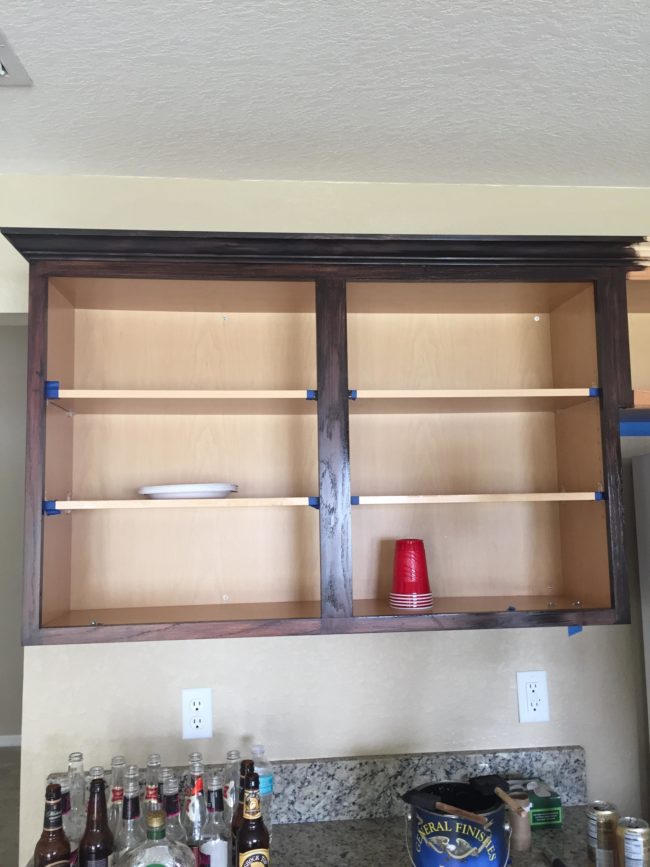 The couple began by removing the doors and drawers to give them a light sanding before applying the stain.