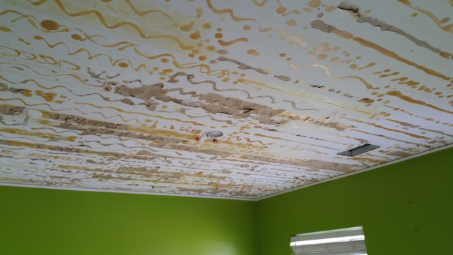 His wife thought a wood ceiling would look cool, so the duo tried gluing vinyl floor tiles to it. Unfortunately, they fell off after only a few days.