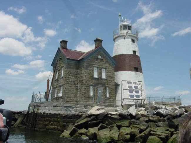Execution Rocks is located in the middle of the Long Island Sound between New Rochelle and Sands Point, New York. Since the 1840s, the lighthouse has helped guide ships coming into New York Harbor.