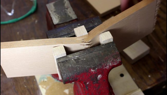 Using a few blocks of wood to break it in the right place, he split the plank with a vise.