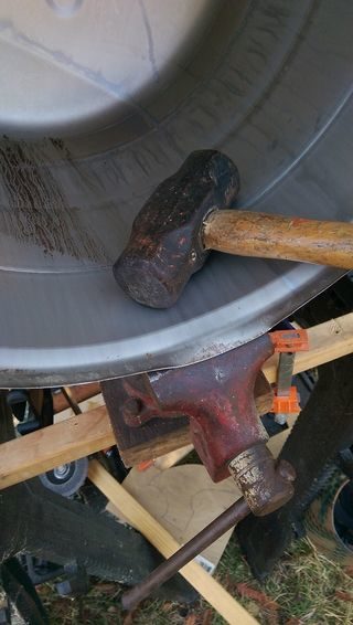 The builder wanted the top part of the keg to fit onto the bottom with a small overlap, so he pounded the edge to create an outward curve.