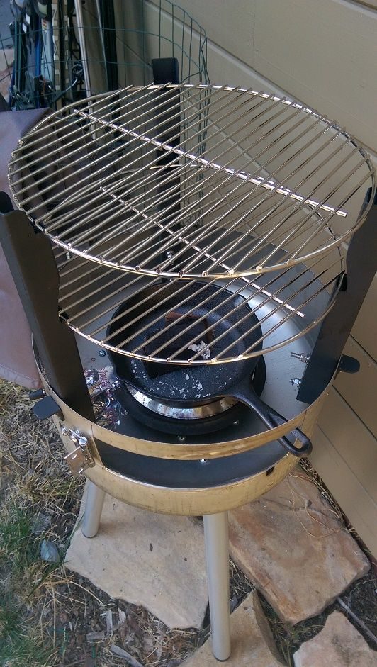 To help the smoker accommodate two grills, he cut and sanded three pieces of steel piping before painting and screwing them in.