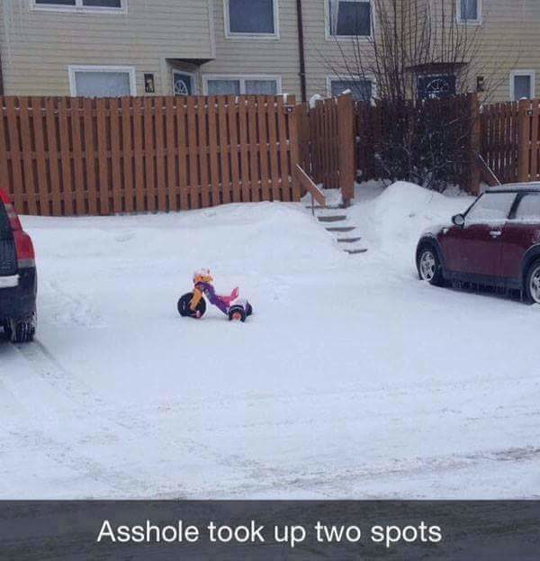 Finding a spot in the snow can be difficult, but no worries, this tyke found a space (or two) for his bike.