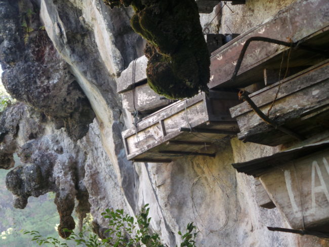 The coffins are attached by building beams into the mountainsides or by simply placing the coffins on pre-existing rock ledges.