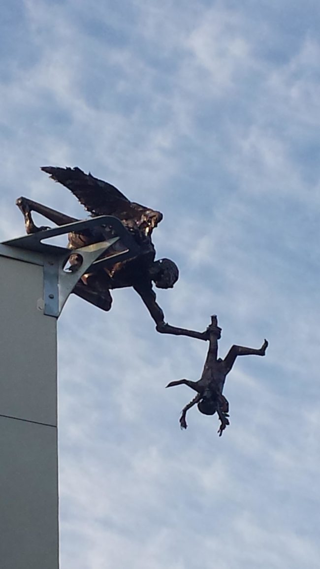 The meaning of this sculpture is supposed to be teaching your children to fly, but it looks more like a poor kid that's about to be murdered.