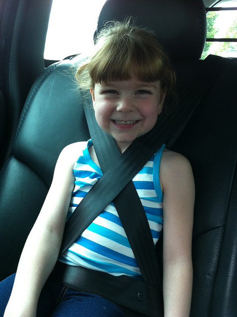 Seat belt shoulder straps should never be placed behind the child or crossed anywhere except the shoulder.