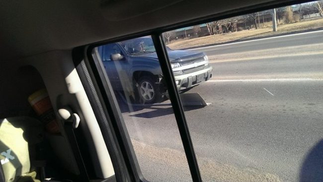 The person driving this car was texting when she hit a sign.  She just kept going with a flat tire while dragging the sign along.