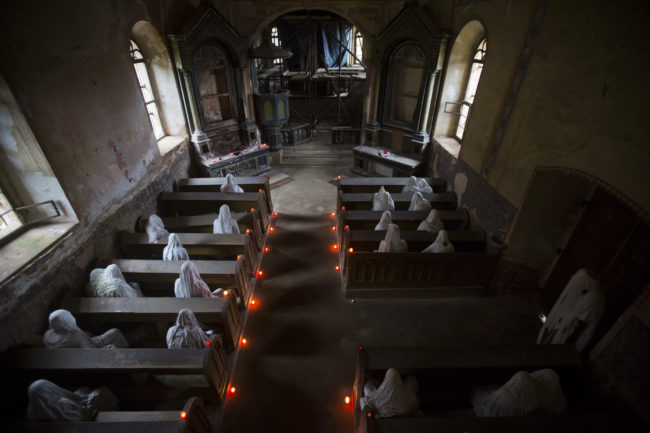 Inside is a completely different story. The pews are lined with hooded "ghosts" that represent the Sudeten Germans who used to live in the area.