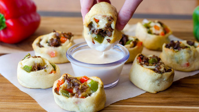 Bake these <a href="https://www.pillsbury.com/recipes/philly-cheesesteak-roll-ups/1bb861d9-8a40-423c-b2d1-e8499e2df6fc?crlt.pid=camp.lkrxvkugvxbj" target="_blank">Philly cheesesteak roll-ups</a> until golden brown, then serve with warm Alfredo sauce for dipping.