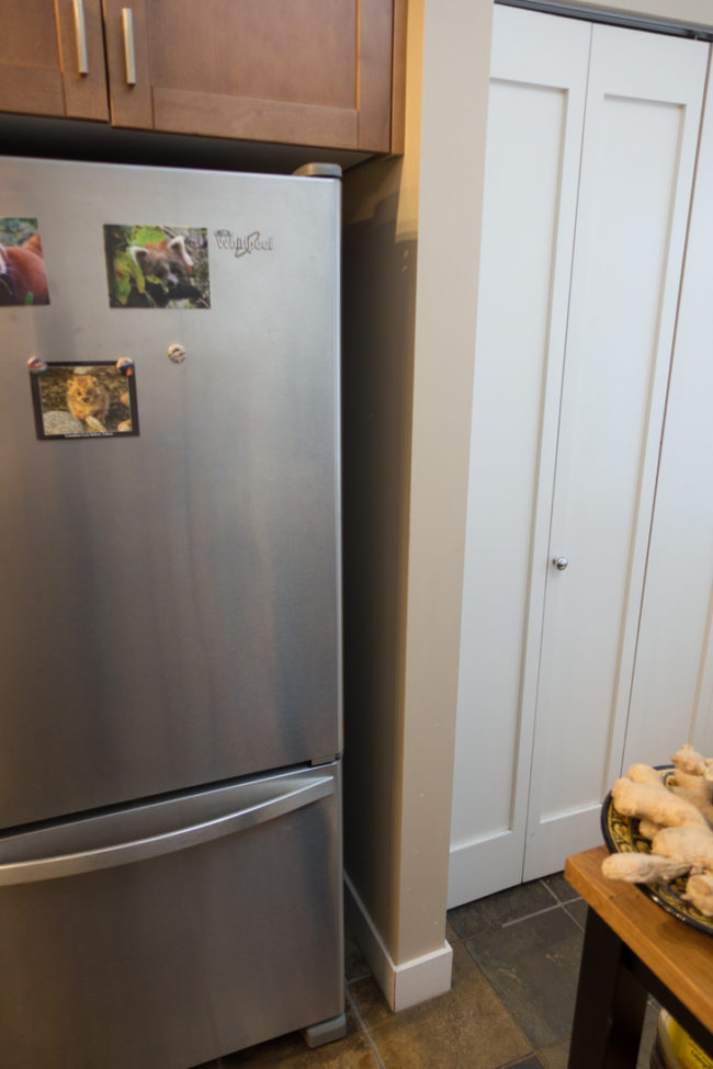 That's when he noticed a mason jar-sized space beside his refrigerator and came up with a genius plan to build a roll-out spice rack.